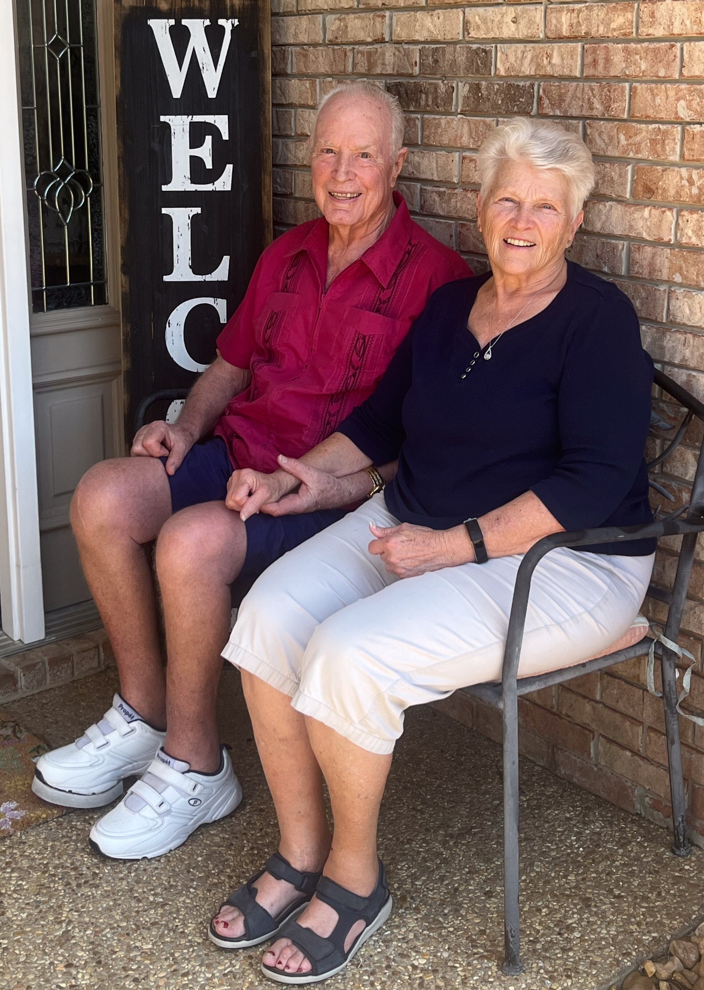 John and Linda Orton sitting on a bench on their front porch