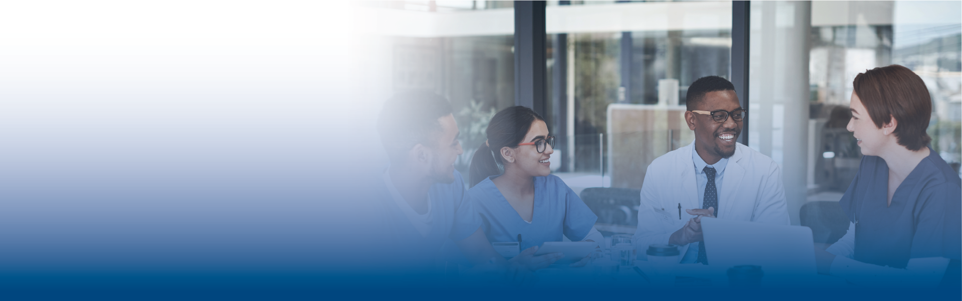 several health care staff are meeting around a table