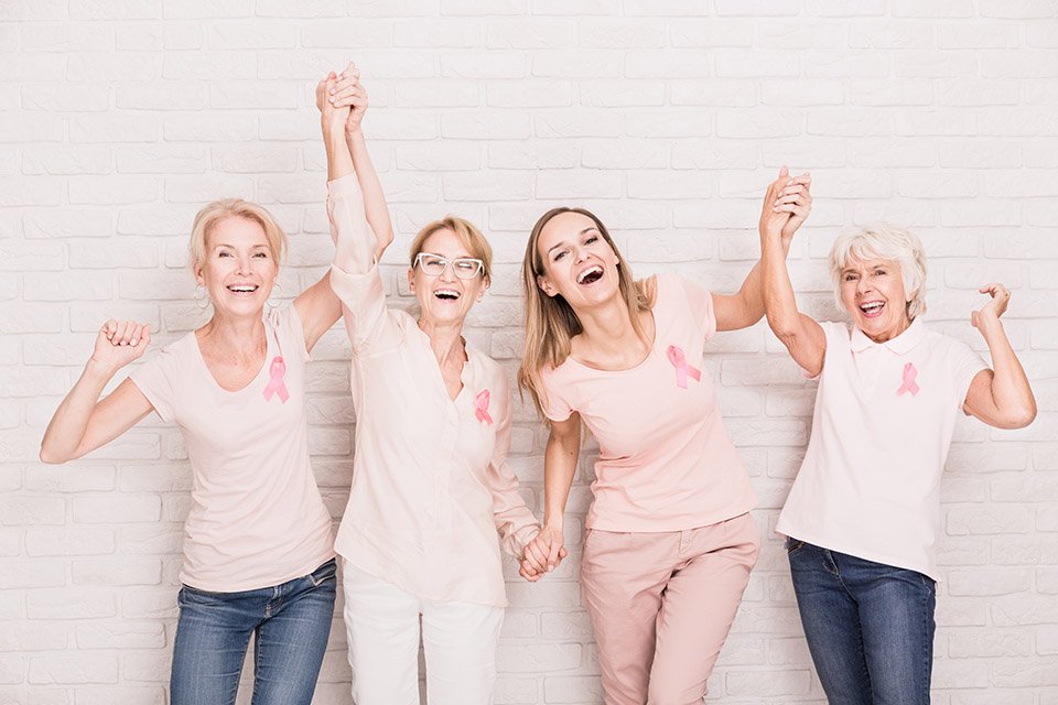 breast cancer survivors holding hands