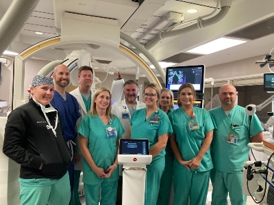 group pic of staff in front of Ion machine