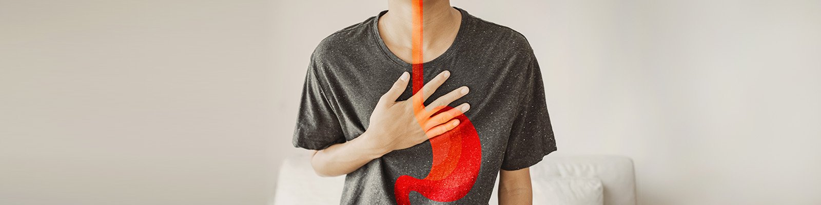 a man holding his hand over his chest with an illustration of the esophagus and stomach over his body