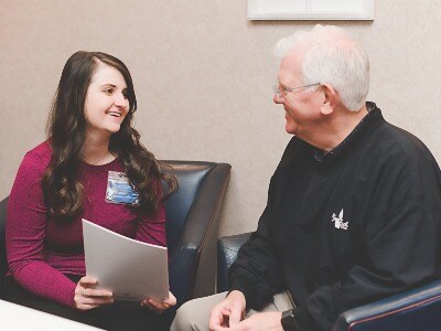 NMMC Cancer Care social worker talks with an older man 