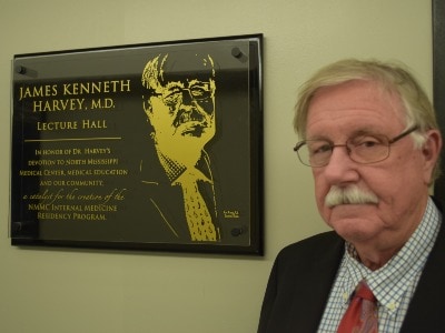 Dr Harvey with plaque