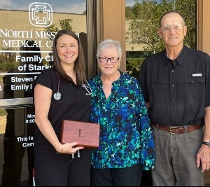 Dr. Landrum with Rosemary and Paul Cuicchi, holding a box made by Paul