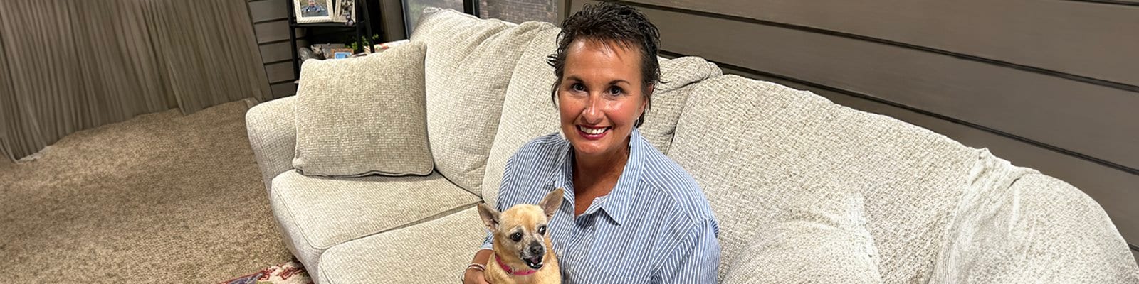 Cindy Murphy and her chihuahua, Edie, on a sofa