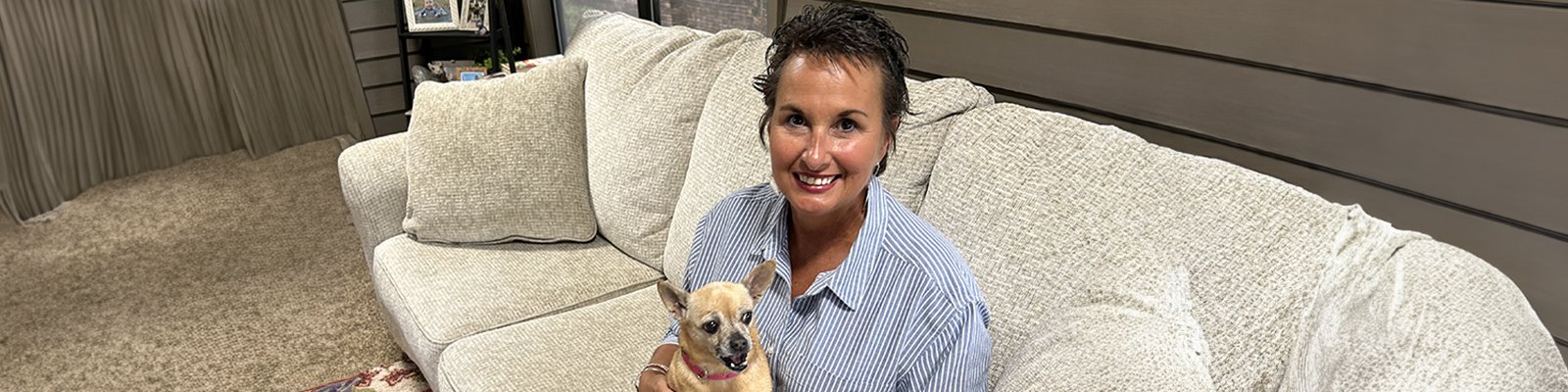 Cindy Murphy and her chihuahua, Edie, on a sofa